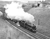 Preserved Black 5 No. 45407 and A3 <I>Flying Scotsman</I> dig in on the ascent of Lindal Bank, while working a railtour between Carnforth and Sellafield in May 1977. Taken at Rowe Head, about a mile and a half west of Ulverston.<br><br>[Bill Jamieson 07/05/1977]