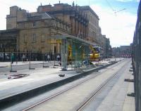 A sunny morning in St Andrew Square on 20 June 2013 looking south towards Princes Street. With the wires now in place construction work on the tram stop has recommenced.<br><br>[F Furnevel 20/06/2013]