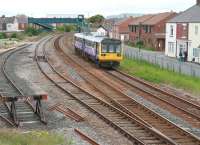The 12.30 Northern Trains Saltburn - Darlington service runs parallel with Birdsall Row on the eastern approach to Redcar Central on 5 June 2013. The edge of The North Yorkshire Moors can be seen beyond the rooftops.<br><br>[John Furnevel 05/06/2013]