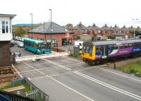 <I>Northern</I> meets <I>Arriva</I> at Redcar Central on 5 June. The Northern 12.53 Darlington - Saltburn train and the Arriva 12.32 Middlesbrough - Redcar bus say hello at West Dyke Road level crossing alongside Redcar Central station.<br><br>[John Furnevel 05/06/2013]