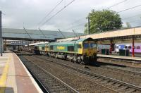 A heavy ballast train is double headed north through Lancaster station on 24 May. Freightliner's 66514 and 66615 are on the Down Through line, probably heading for Carlisle New Yard.<br><br>[Mark Bartlett 24/05/2013]