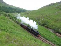 In the shadow of Druim na Brein-choille, west of Glenfinnan station, Ian Riley's 5MT 4-6-0 44871 climbs towards the summit with a <I>Jacobite</I> service for Mallaig in June 2013. <br><br>[Malcolm Chattwood 26/06/2013]