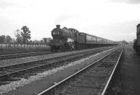 GWR Castle class 4-6-0 no 5026 <I>Criccieth Castle</I> races past Banbury shed in the summer of 1962 with a down express.<br><br>[K A Gray 15/08/1962]
