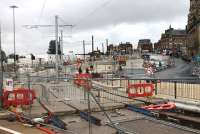 Metrolink street works in Oldham as seen from a passing Rochdale to East Didsbury tram. Completed in January 2014, trams now turn right at this point to pass through the town centre to rejoin the railway line formation at Werneth. The new Mumps tram stop is seen being built near the buildings at the top of the hill. [See image 44095] for a  view of this location in the opposite direction. <br><br>[Mark Bartlett 31/07/2013]