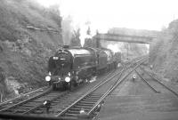 30925 <I>Cheltenham</I> and 40646 running round at Wetherby South Junction on 13 May 1962 under the A661 road bridge. The train standing in Wetherby station behind the camera is the RCTS <I>East Midlander No 5</I> on its way from Church Fenton to Harrogate. The run round here was necessitated by the closure of the direct line between Wetherby East and West Junctions in 1961. Wetherby station closed in January 1964 and the site is now a walkway and car park. [See image 54833]<br><br>[K A Gray 13/05/1962]
