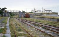 The Tralee - Fenit branch of the Great Southern & Western Railway was finally closed in 1987 but lingers on.There was an attempt to revive it as a preserved line, which explains the presence of a Ruston shunter, but the scheme was abandoned. View back towards Tralee in 1991. [See image 44546] <br><br>[Bill Roberton //1991]