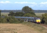 One of the NXEA loco-hauled Great Yarmouth - Norwich services coming off the Berney Arms route on 2 July 2011. 1V43 is seen from Mill Road Bridge approaching Reedham Junction behind DRS 47810.<br><br>[Ian Dinmore 02/07/2011]