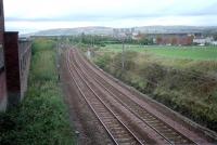 An October 2001 view west over the site of the former junction for Clydebank East, the 1882 terminus of the Glasgow, Yoker and Clydebank Railway.  The continuation of 1897 to Dalmuir is to the right. Clydebank East station closed in 1959 [see image 7524].<br>
<br><br>[Ewan Crawford 13/10/2001]