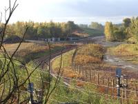 The start of the Borders Railway at the north end of Millerhill yard, seen looking south west over the junction in early morning autumn sunshine on 20 October 2013. Beyond the buffer stops at the end of the turnback siding trackbed preparations continue towards what will become Shawfair station. <br><br>[John Furnevel 20/10/2013]