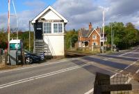 Looking north over the level crossing on the busy A46 road at Holton-le-Moor, Lincolnshire, on 9 October, with the former station building opposite. <br><br>[John McIntyre 09/10/2013]