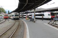 Vevey, on the shore of Lake Geneva, is a meeting point for metre and standard gauge networks. Here an articulated unit on a Blonay service waits to leave the narrow gauge platform with an older single car stabled alongside. On the right a SBB EMU waits in a standard gauge bay.<br><br>[Mark Bartlett 10/09/2013]