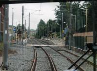 Metrolink driver's view from a Manchester bound tram entering Derker station. The original wooden platforms, from when the station opened to replace Royton Junction in 1985, were replaced when Metrolink rebuilt the line after the 2009 closure. [See image 21153] for a <I>heavy rail</I> view of this location. <br><br>[Mark Bartlett 31/07/2013]