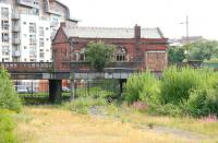 Looking east across the overgrown platforms at Partick Central in August 2006, with the old booking office standing above on Benalder Street. The station opened in 1896 and closed to passengers in 1964, after undergoing a name change to Kelvin Hall for its final 5 years. The building was demolished 5 months later [see image 13369].<br><br>[John Furnevel 27/08/2006]