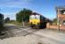 DBS 66016 travels south towards Lincoln as it crosses Claxby Gatehouse AHBC with a loaded coal train from Immingham on 9 October 2013.<br><br>[John McIntyre 09/10/2013]