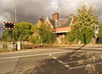 The former station building at North Kelsey on 9 October 2013, looking over the level crossing towards Barnetby. The weak sunshine is just about to give way to the threatening skies overhead!<br><br>[John McIntyre 09/10/2013]