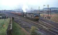 An EE Type 4 pilots Kingmoor Black 5 no 45138 past Strawfrank Junction (now Carstairs South) with a lengthy Liverpool/Manchester train in the summer of 1964.  <br><br>[John Robin 24/07/1964]