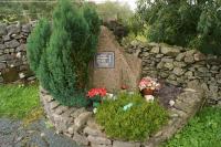 The memorial at Tebay to four track workers, Colin Buckley, Darren Burgess, Gary Tindall and Chris Waters who were killed by a runaway PW trolley on 15 February 2004 while maintaining the railway. The WCML is on the other side of the wall to the left.<br><br>[John McIntyre 13/02/2014]