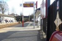 Platform view south at Horsforth station on 19 March with the 15.12 service to Knaresborough just appearing below the road bridge in the background. Note the three quarter mile post on the right. <br><br>[Bruce McCartney 19/03/2014]