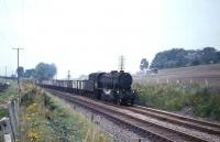 WD 2-8-0 no 90199 passing Cumbernauld with a freight in August 1965.<br><br>[G W Robin 31/08/1965]
