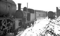 J77 0-6-0T no 68431 standing in the snow on Darlington shed in March 1960. The locomotive had been withdrawn from York on the last day of February and was cut up in the nearby works by the end of the following month. The long shed in the background housed the Darlington breakdown crane.<br><br>[K A Gray //1960]