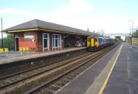 An eastbound service calls at St Helens Junction on 19 April 2014. It may no longer be a junction station but at least it retains a platform building (original?)<br><br>[John McIntyre 19/04/2014]
