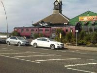 A Mark 1 carriage outside <I>The Rattler</I> Bar and Restaurant alongside the coast road at Marsden, South Shields, in July 2014. Named after <I>The Marsden Rattler</I> - the line opened by the Whitburn Coal Company from South Shields (Westoe Lane) to Whitburn Colliery in 1879 - which roughly followed the route of the current road. The line closed to passengers in 1953, but continued to transport coal until the pit closed in 1968.<br><br>[David Pesterfield 06/07/2014]