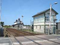 Valley station looking west towards Holyhead in July 2014 showing the original up side building and signal box.  The box controls the level crossing, a crossover at the far end of the station, access to the nuclear flask loading facility and the local semaphore signals.<br><br>[David Pesterfield 23/07/2014]