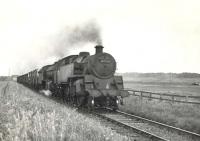 BR Standard class 4 tank 80021 pilots Gresley K2 61782 <I>Loch Eil</I> near Philorth Halt on 9 August 1953 at the head of a lengthy fish train from Fraserburgh. <br><br>[G H Robin collection by courtesy of the Mitchell Library, Glasgow 09/08/1953]
