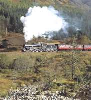 The  motion and wheels of 45407 reflect a nice glint as the Black 5 climbs away from Glenfinnan towards the summit between Lochs Eil and Eilt with the westbound <I>Jacobite</I> on 15 October 2014. Photographed across the Abhainn Shlatach about a mile west of Glenfinnan station.<br><br>[Bill Jamieson 15/10/2014]