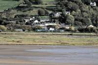 View from Portmeirion village across the Dwyryd estuary as the 1613 service to Machynlleth leaves Talsarnau on 10th October 2014.<br><br>[Colin McDonald 10/10/2014]