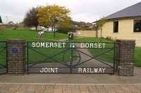 A set of gates at the entrance to 'The Railway Gardens' in Sturminster Newton in October 2014, with the name of the company which operated the railway. The blue plaque on the left gate post and placed there by the S&DJR Trust is inscribed <I<>Here once passed the engines and men of the Somerset & Dorset Joint Railway, Closed 7 March 1966</I>. <br><br>[John McIntyre 22/10/2014]