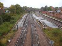 Looking north over the almost intact Rotherham Masborough station in October 2014 (closed October 1988), showing the passenger lines used by cross country services in the foreground and the goods lines to Chesterfield, avoiding Sheffield, over to the right. A goods loop line still exists, albeit covered in vegetation, on the far left. [See image 41035]<br><br>[David Pesterfield 13/10/2014]