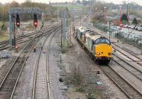 Two Class 37s take the Down Fast through Lancaster station on 6 November, avoiding the platform road. DRS 37610 and 37602 are on the morning Crewe - Sellafield nuclear flasks service.<br><br>[Mark Bartlett 06/11/2014]