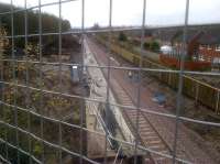A relatively tidy looking Newtongrange station site on 25 November 2014, photographed looking south from the A7 overbridge. Platform construction looks well advanced and a noise barrier has been erected between the new railway and the gardens of Jenks Loan. Work is in progress on the main entrance and car park off to the left.  <br><br>[John Yellowlees 25/11/2014]