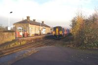 150270 arrives at Littleborough with a westbound service to Manchester Victoria on 29 November 2014. The main station building on the eastbound platform is now a local history centre.<br><br>[John McIntyre 29/11/2014]