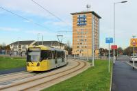 The brand new tram line to Manchester Airport opened in November 2014, over a  year early. The line involves a mixture of reserved and street running sections. One month after opening, Metrolink 3063 swings round the 15mph curve just to the north of Benchill tram stop heading for Manchester. <br><br>[Mark Bartlett 02/12/2014]