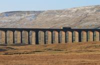 The low winter sun illuminates the underside of Ribblehead's arches as Freightliner 66550 makes a light engine run from Carlisle to Leeds on 28th December. <br><br>[Mark Bartlett 28/12/2014]