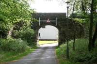 Old preserved overbridge crossing the trackbed of the line heading east out of Peebles towards Galashiels. The route now provides access to 'The Bridges' housing development. For the view from the other side [see image 31892].<br><br>[John Furnevel 21/05/2010]