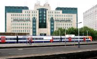 A South West Trains service for Waterloo standing at Vauxhall station in July 2005 in front of a ...well... a certain government building ...errr ...'nuff said...<br><br>[John Furnevel 24/07/2005]
