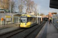 A Manchester bound tram (3070) calls at West Didsbury on 17th January. The original Withington & West Didsbury railway station, closed in 1961, lay just beyond the overbridge but the new tram station is much better located for the village centre.  <br><br>[Mark Bartlett 17/01/2015]