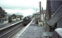 Station scene at Thankerton, South Lanarkshire, in September 1964, as Jubilee 45627 <I>Sierra Leone</I> passes through northbound with a Liverpool - Glasgow relief service. The 1848 station was finally closed to passengers four months later. <br><br>[John Robin 26/09/1964]