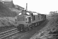 Late on the afternoon of 9 February 1970 and not far from journey's end at Millerhill Yard, EE Type 3 No D6903 negotiates the sharp reverse curves between Blackford Hill and Newington with the 13:22 partially fitted freight from Carlisle New Yard. Until just over a year earlier this train had been booked to run as an unfitted through train (8S50) over the Waverley Route, departing from Carlisle only a few minutes later, but train classifications had been altered in the interim.<br><br>[Bill Jamieson 09/02/1970]