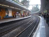 A view north along the curving platforms of Cite Universitaire station, located on the south side of Paris on RER Line B that runs between Aeroport Charles de Gaulle 2 and Saint Remy de Chevreuse.<br><br>[David Pesterfield 25/02/2015]