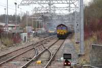Just visible through the haze of 66156's exhaust the driver of 320307 returns to his cab after contacting the signaller.  It's fairly certain the reason for the delay became apparent before the call was completed.<br><br>[Malcolm Chattwood 05/03/2015]