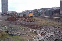 26011 shunting scrap wagons in the former Camlachie Goods Yard, here reduced to a single track serving a scrapyard in 1988. [See image 51978]<br><br>[Ewan Crawford //1988]