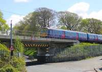 Crossing the low bridge over Torrisholme Road in Lancaster on 12th May 2015 is ex-Thameslink 319366, on yet another Northern driver training run between Preston and Carnforth. The train has just crossed the River Lune and is now approaching the junction for the Morecambe branch. <br><br>[Mark Bartlett 12/05/2015]