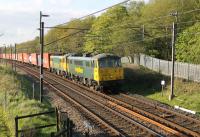 86613 and 86622, two of the 16 strong Freightliner Class 86 fleet, take the evening Coatbridge to Crewe train south at Scorton on 13th May 2015. The former E3148 and E3174 are approaching the footbridge at Broad Fall Farm. <br><br>[Mark Bartlett 13/05/2015]