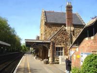 Looking west along the London bound platform at Sherborne in May 2015 showing the 1860 station building, complete with platform canopy. Part of the covered footbridge staircase stands on the right. <br><br>[David Pesterfield 12/05/2015]