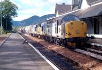 A pair of class 37s with a cement train southbound through Dunkeld in 1990.<br><br>[Ewan Crawford //1990]