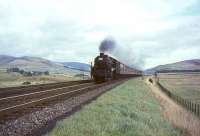 Black 5 44993 deputising for a diesel on a Glasgow - Manchester train in September 1964, photographed running to time north of Abington.<br><br>[John Robin 26/09/1964]